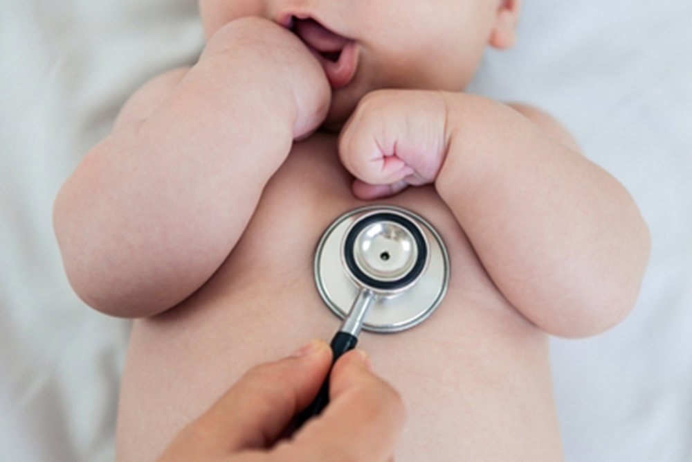 Female doctor examining baby boy toddler listening to lungs with stethoscope. A nurse having medical checkup with sick little newborn patient in clinic. Pediatrician's appointment, healthcare concept